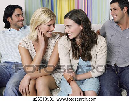 Group of young people sitting in row on sofa View Large Photo Image Stock Photography - Group of young people sitting in row on sofa. Fotosearch