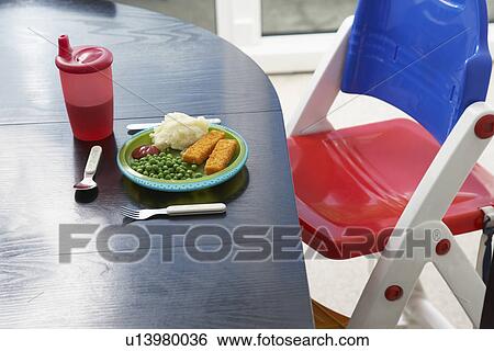 High chair at table with child's dinner close-up View Large Photo Image Stock Photograph - High chair at table with child's dinner close-up. Fotosearch