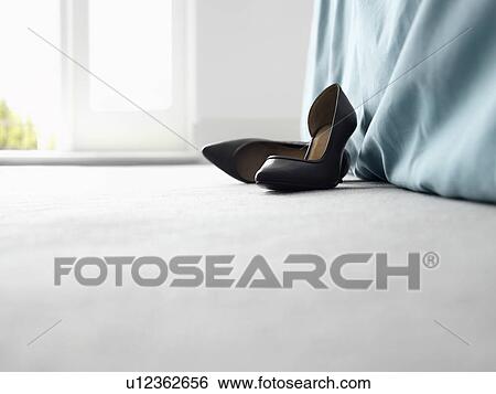 High heeled shoes by bed surface view View Large Photo Image Stock Photograph - High heeled shoes by bed surface view. Fotosearch