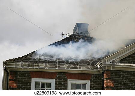 Stock Photo - House roof on fire. Fotosearch