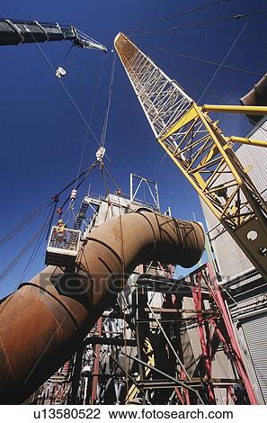 Stock Image - Installing fume extraction pipe into steel foundry smelter. Fotosearch