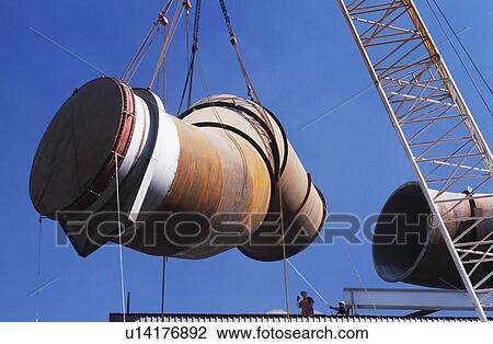 Stock Image - Installing fume extraction pipe into steel foundry smelter. Fotosearch
