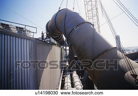 Stock Image - Installing fume extraction pipe into steel foundry smelter. Fotosearch