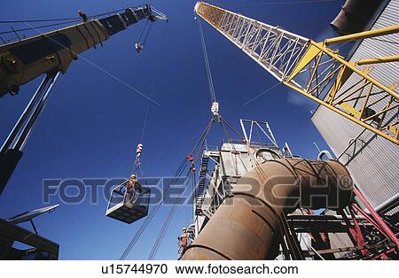 Stock Image - Installing fume extraction pipe into steel foundry smelter. Fotosearch