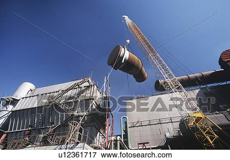 Installing fume extraction pipe into steel foundry smelter View Large Photo Image Stock Photo - Installing fume extraction pipe into steel foundry smelter. Fotosearch