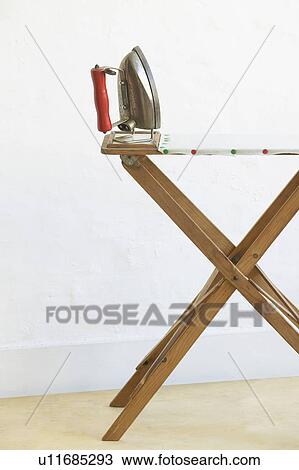 Iron on ironing board View Large Photo Image Stock Image - Iron on ironing board. Fotosearch