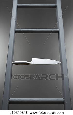 Kitchen knife in place of step in ladder View Large Photo Image Stock Photo - Kitchen knife in place of step in ladder. Fotosearch