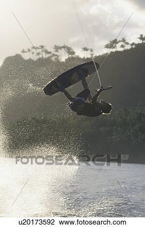Stock Image - Kitesurfer jumping. Fotosearch