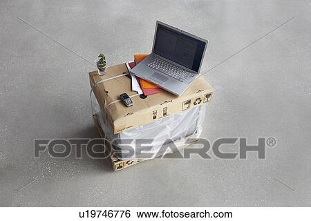 Stock Photograph - Laptop on top of boxes. Fotosearch