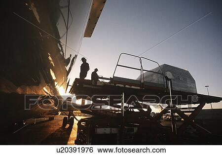 Loading freight onto Boeing 727 jet aircraft View Large Photo Image Stock Photograph - Loading freight onto Boeing 727 jet aircraft. Fotosearch