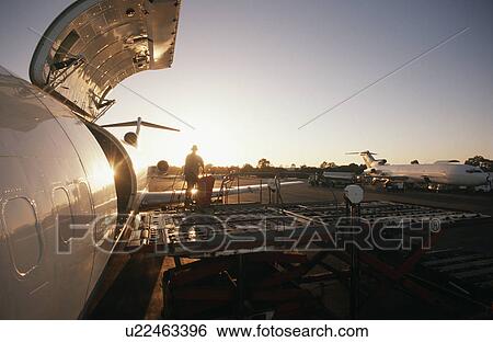 Loading freight onto Boeing 727 jet aircraft View Large Photo Image Stock Photograph - Loading freight onto Boeing 727 jet aircraft. Fotosearch