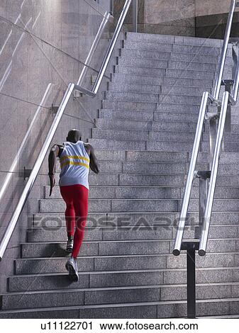 Male athlete running up staircase outside building View Large Photo Image Stock Image - Male athlete running up staircase outside building. Fotosearch