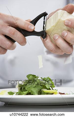 Male chef grating cheese over salad mid section View Large Photo Image Stock Image - Male chef grating cheese over salad mid section. Fotosearch