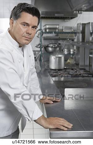 Male chef in kitchen portrait View Large Photo Image Stock Photograph - Male chef in kitchen portrait. Fotosearch