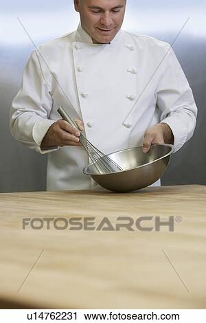Male chef mixing ingredients using whisk in kitchen View Large Photo Image Stock Image - Male chef mixing ingredients using whisk in kitchen. Fotosearch