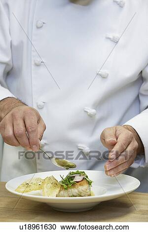Stock Image - Male chef preparing food close-up. Fotosearch