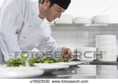 Male chef preparing salad in kitchen View Large Photo Image Stock Image - Male chef preparing salad in kitchen. Fotosearch