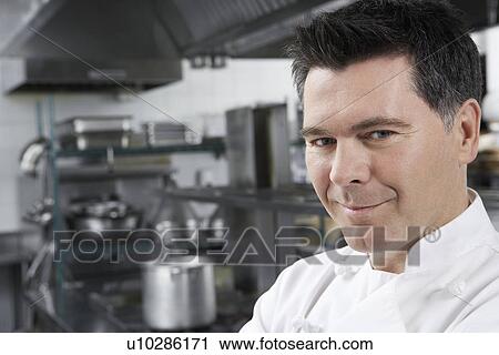 Male chef smiling in kitchen portrait View Large Photo Image Stock Image - Male chef smiling in kitchen portrait. Fotosearch