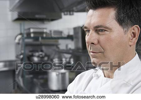 Male chef smiling in kitchen View Large Photo Image Stock Image - Male chef smiling in kitchen. Fotosearch