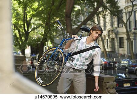Man carrying bicycle descending steps View Large Photo Image Stock Photography - Man carrying bicycle descending steps. Fotosearch