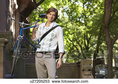 Man carrying bicycle portrait View Large Photo Image Stock Image - Man carrying bicycle portrait. Fotosearch