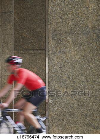 Man cycling between pillars motion blur View Large Photo Image Picture - Man cycling between pillars motion blur. Fotosearch