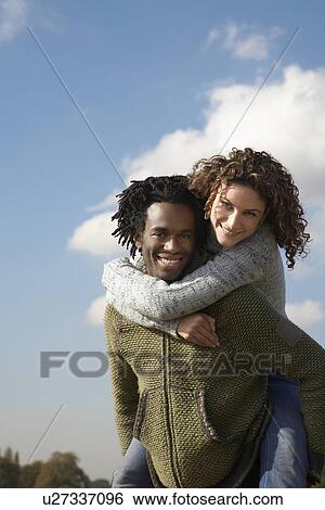Man giving woman piggyback View Large Photo Image Stock Photograph - Man giving woman piggyback. Fotosearch