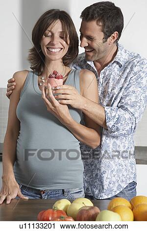 Man handing pregnant woman strawberry shortcake in kitchen View Large Photo Image Stock Image - Man handing pregnant woman strawberry shortcake in kitchen. Fotosearch