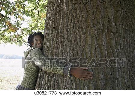 Man hugging tree View Large Photo Image Stock Image - Man hugging tree. Fotosearch