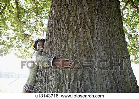 Man hugging tree View Large Photo Image Stock Photograph - Man hugging tree. Fotosearch