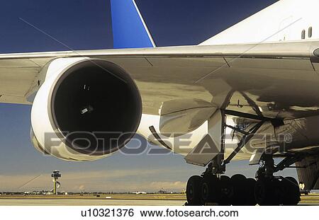 Stock Photograph - Man inspecting engine of passenger jet. Fotosearch
