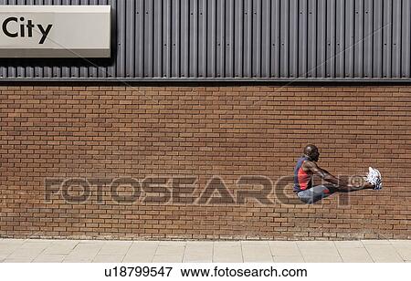 Man jumping by wall with 'city' written on it View Large Photo Image Stock Photo - Man jumping by wall with 'city' written on it. Fotosearch