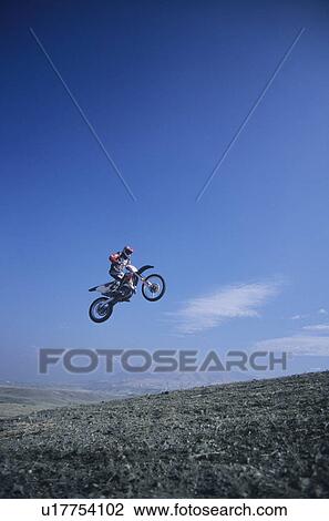 Man jumping on motorbike View Large Photo Image Stock Image - Man jumping on motorbike. Fotosearch