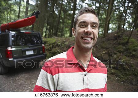 Man near car in forest smiling portrait View Large Photo Image Stock Photograph - Man near car in forest smiling portrait. Fotosearch