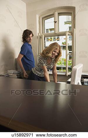 Man pinching woman's bottom in office View Large Photo Image Stock Image - Man pinching woman's bottom in office. Fotosearch