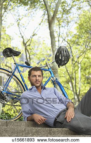 Stock Image - Man relaxing in park portrait. Fotosearch