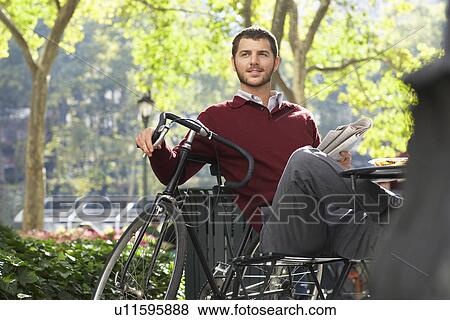 Stock Photo - Man relaxingin park. Fotosearch