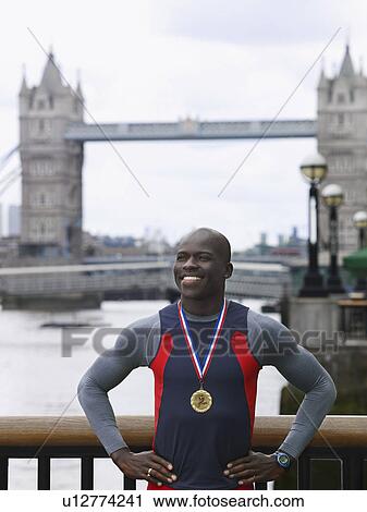 Man standing in front of Tower Bridge wearing medal England London View Large Photo Image Stock Image - Man standing in front of Tower Bridge wearing medal England London. Fotosearch