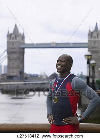 Man standing in front of Tower Bridge wearing medal England London View Large Photo Image Stock Image - Man standing in front of Tower Bridge wearing medal England London. Fotosearch