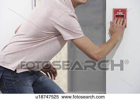 Man starting fire alarm indoors View Large Photo Image Stock Photography - Man starting fire alarm indoors. Fotosearch