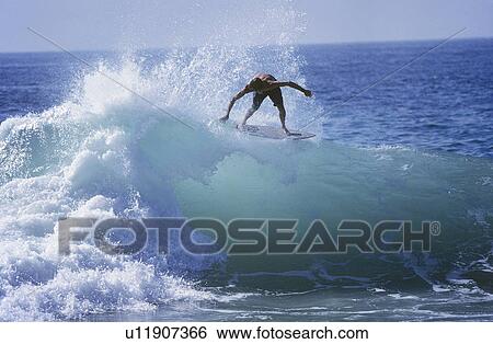Man surfing on ocean wave View Large Photo Image Stock Photograph - Man surfing on ocean wave. Fotosearch