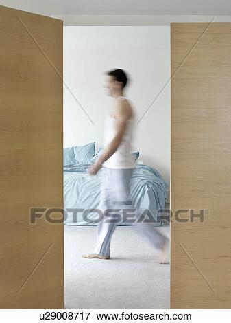 Man walking in bedroom side view (blurred motion) View Large Photo Image Stock Photo - Man walking in bedroom side view (blurred motion). Fotosearch