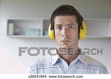 Picture - Man wearing headphones in office portrait. Fotosearch
