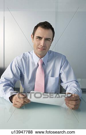 Man wearing shirt and tie in office portrait View Large Photo Image Stock Photo - Man wearing shirt and tie in office portrait. Fotosearch