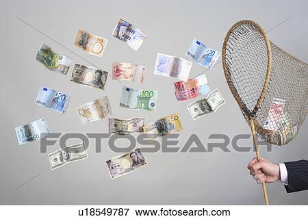 Man's hand holding butterfly net catching flying banknotes View Large Photo Image Stock Photo - Man's hand holding butterfly net catching flying banknotes. Fotosearch