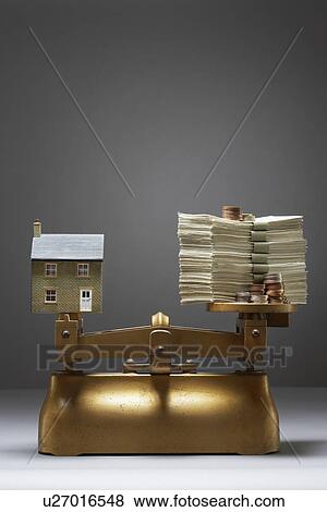 Stock Photo - Model house and money on scales. Fotosearch