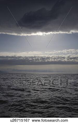 Moody sky over ocean View Large Photo Image Stock Photo - Moody sky over ocean. Fotosearch