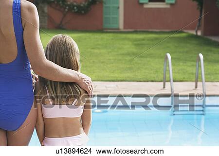 Mother and daughter (5-6) in swimwear by pool back view View Large Photo Image Picture - Mother and daughter (5-6) in swimwear by pool back view. Fotosearch