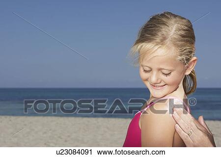 Mother applying sunscreen to daughter (5-6) close-up of hand View Large Photo Image Stock Image - Mother applying sunscreen to daughter (5-6) close-up of hand. Fotosearch