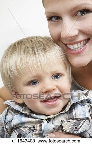 Stock Photo - Mother holding son (1-2) studio shot. Fotosearch